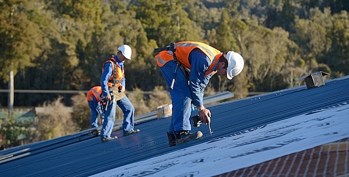 Roofing contractors replacing a commercial roof in Jacksonville, FL