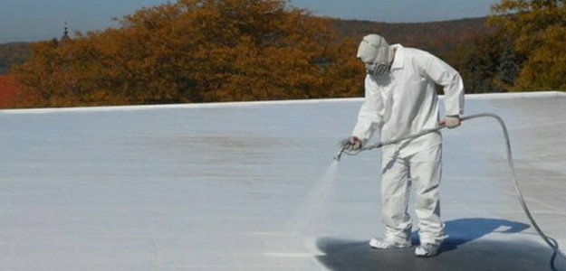 Roofing contractor applying a Rubber Roof Coating in Jacksonville's commercial roof