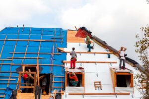 roofers working on roof of home