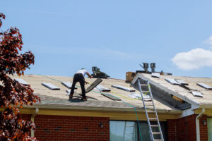 men on roof stripping material