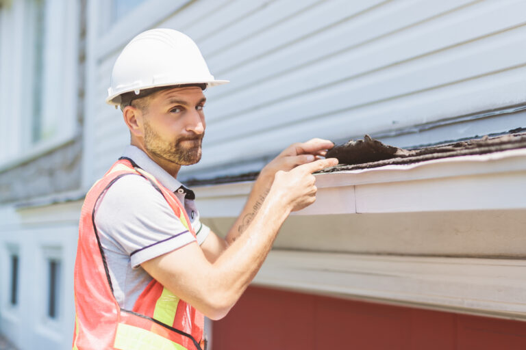 Expert Roofer Inspecting Damaged Shingles